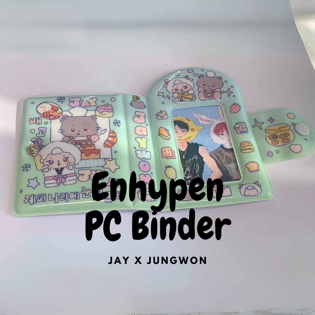 A pastel green photocard binder open on a flat surface, showcasing pockets filled with illustrated cards. The left side displays cute, cartoon-style drawings labeled 'JAY' and 'Jungwon' with whimsical dessert motifs. The right side features a clear pocket with a photocard of ENHYPEN's Jungwon, overlaid with playful graphics. The words "ENHYPEN PC Binder" are emblazoned across the top in bold, with "JAY x JUNGWON" beneath, indicating a special collaboration.