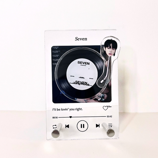 Acrylic display featuring BTS Jungkook with the song title 'Seven' and the lyric 'I'll be lovin' you right.' along with a vinyl record design and playback controls.Acrylic display featuring BTS member Jungkook with the song title 'Seven' and the lyric 'I'll be lovin' you right.' along with a vinyl record design and playback controls.